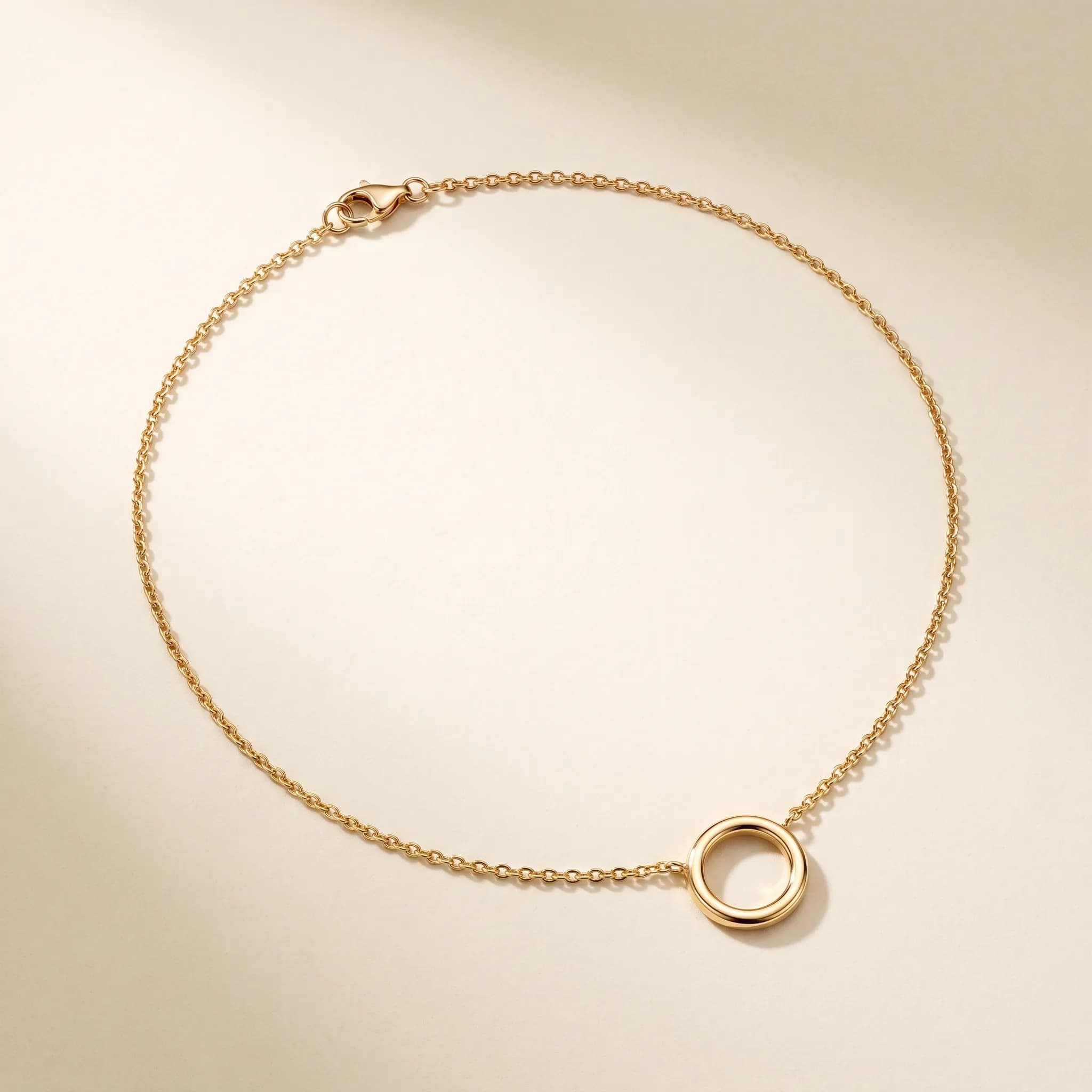 Fine Orbit Pendant, an illustrative yellow-gold tone jewelry concept