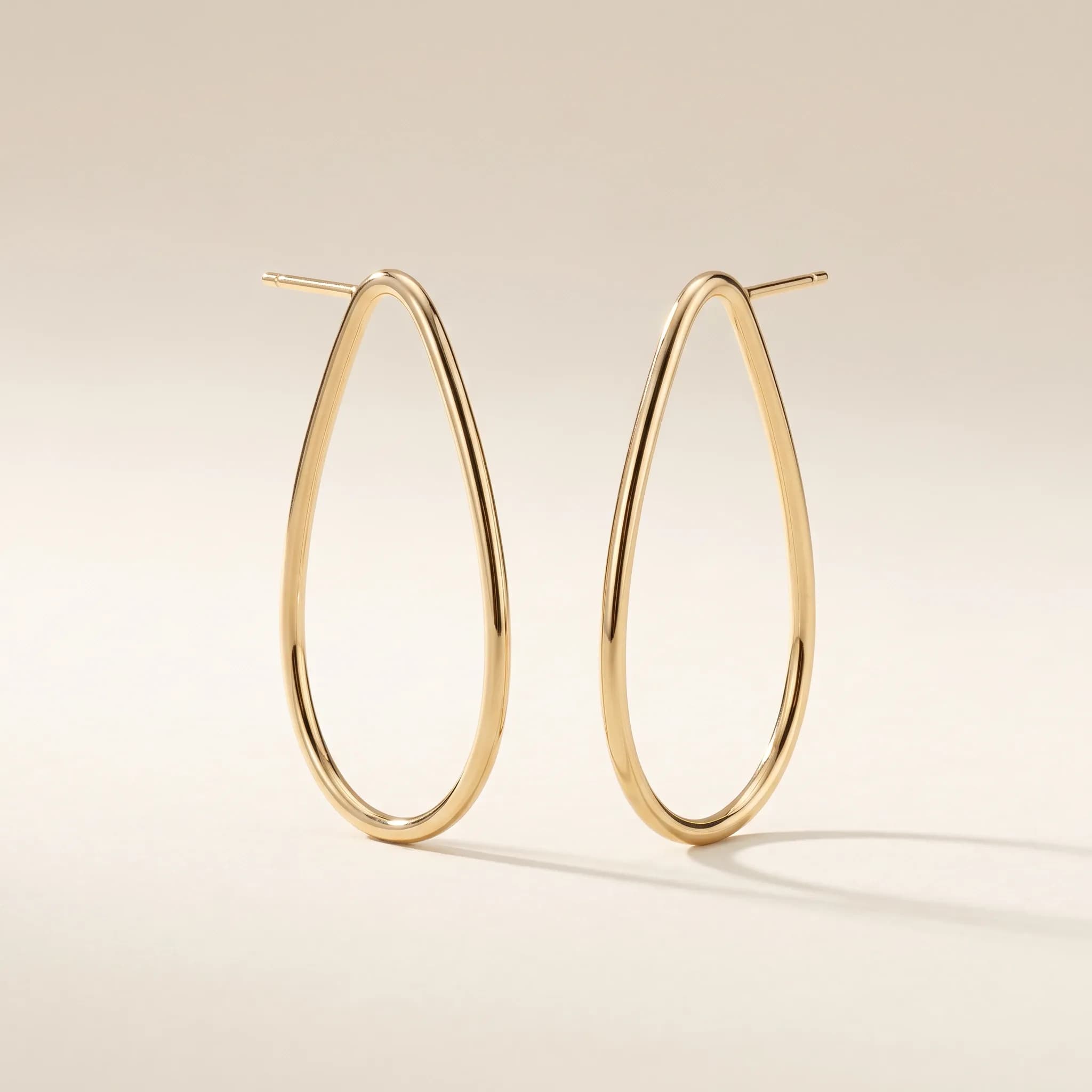 The Contour Earrings, an illustrative yellow-gold tone jewelry concept