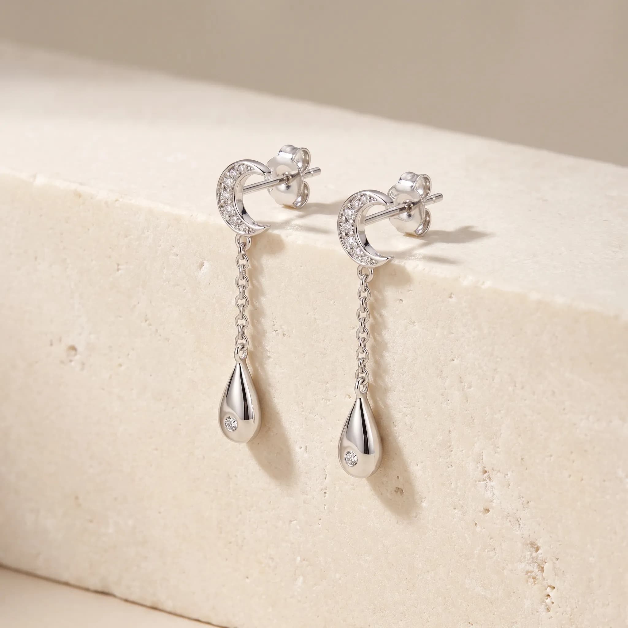 Celestial Drop Earrings, an illustrative white-gold tone jewelry concept